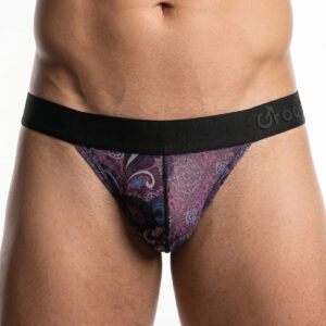 Man wearing a purple paisley patterned thong with a black elastic waistband, front view.