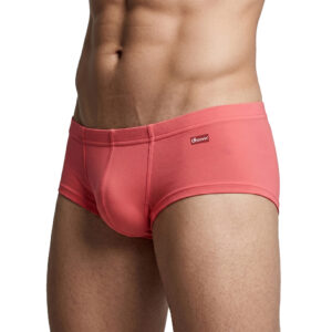 Close-up of a man wearing coral-pink briefs (Groovin brand) showing a snug, seamless fit on the hips and upper thighs.