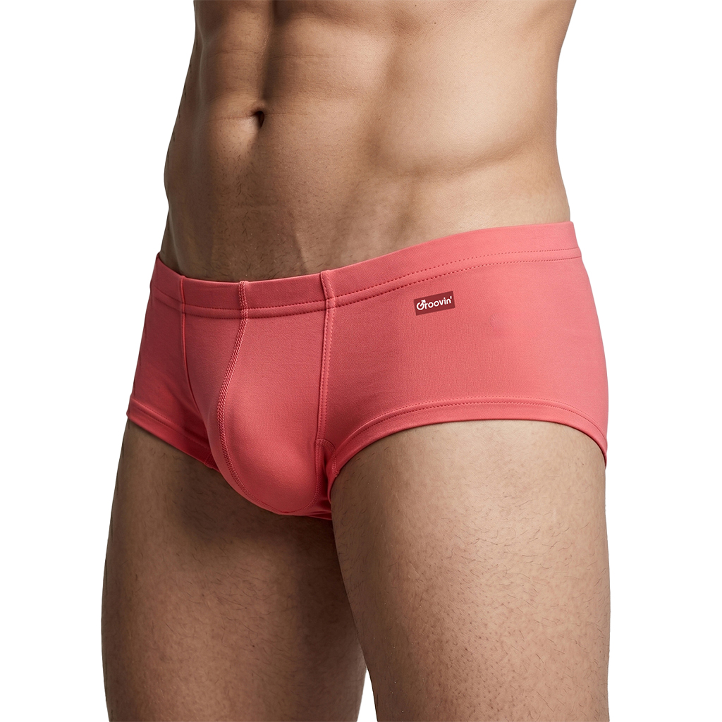 SE2509-sp - Groovin' Online Shop Close-up of a man wearing coral-pink briefs (Groovin brand) showing a snug, seamless fit on the hips and upper thighs.